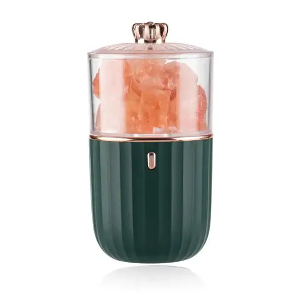 Presse-agrumes électrique en forme de capsule, design moderne avec corps vert foncé et couvercle rose doré, idéal pour extraire le jus d'agrumes frais.