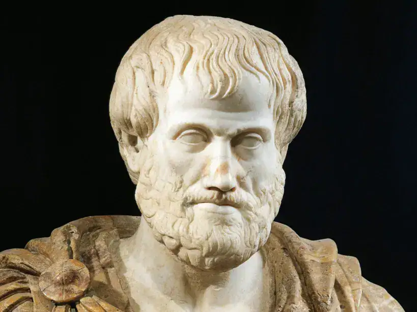 Marble bust of an ancient Greek philosopher with detailed facial features and beard, set against a dark background.