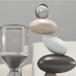 Balancing decorative stones with glass and stone elements.
