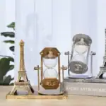 Miniature Eiffel et sablier décoratif en verre et métal doré, parfaits pour une décoration scientifique ou vintage.