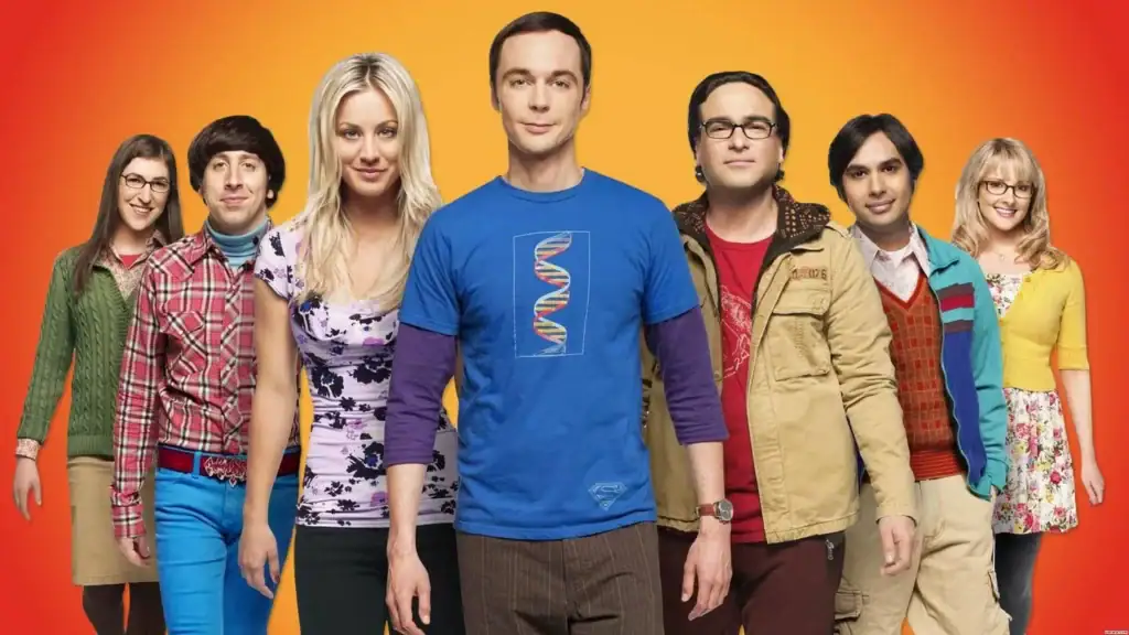 Group of diverse young adults wearing casual clothing, standing together against a vibrant orange background, showcasing a variety of science-themed apparel and accessories.