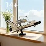 Modèle de navire spatial LEGO détaillé avec éléments techniques, exposé sur une fenêtre ensoleillée, idéal pour collectionneurs et passionnés de science-fiction.